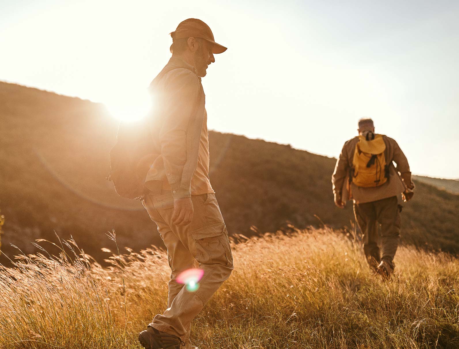 A senior on a hike with his adult son